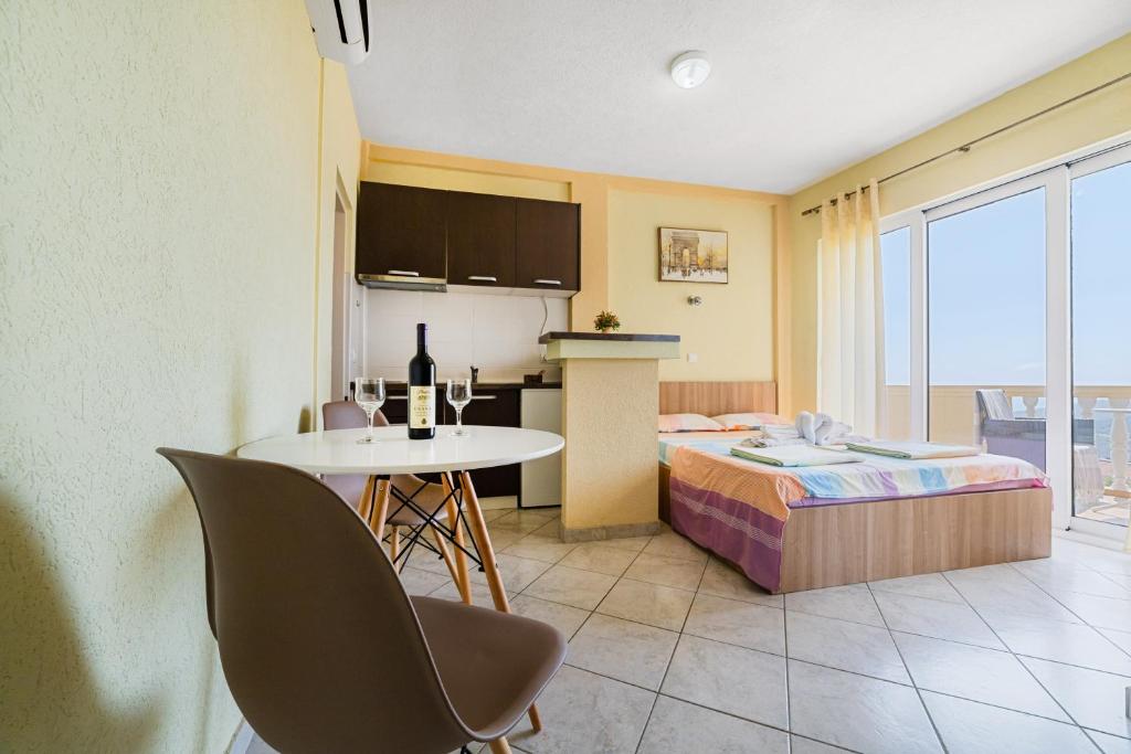 a room with a bed and a table and a kitchen at Apartment Dragicevic 5 with Garage in Budva