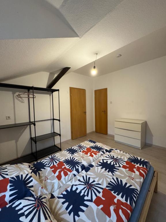a bedroom with a large bed with a colorful comforter at Platin Apartment in Wuppertal