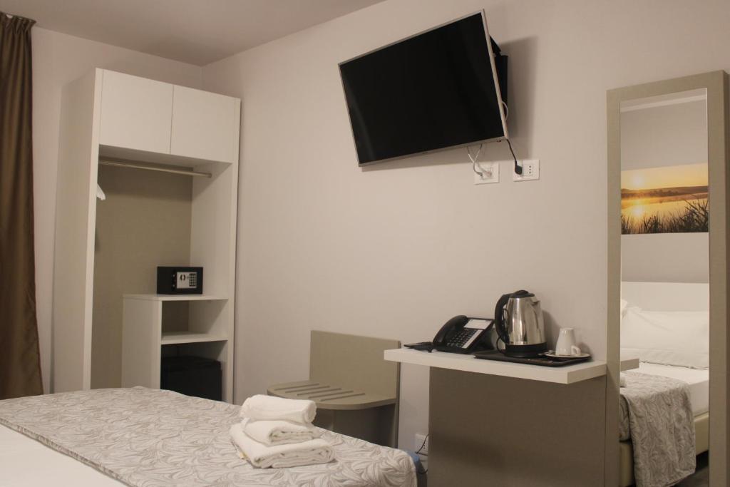 Postel nebo postele na pokoji v ubytování Hotel Acquario