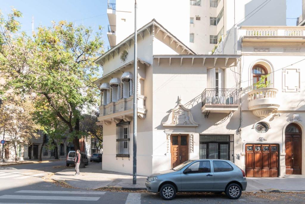 a car parked in front of a white building at Fliphaus Mansion Paz A 10 pax Deluxe House Belgrano in Buenos Aires