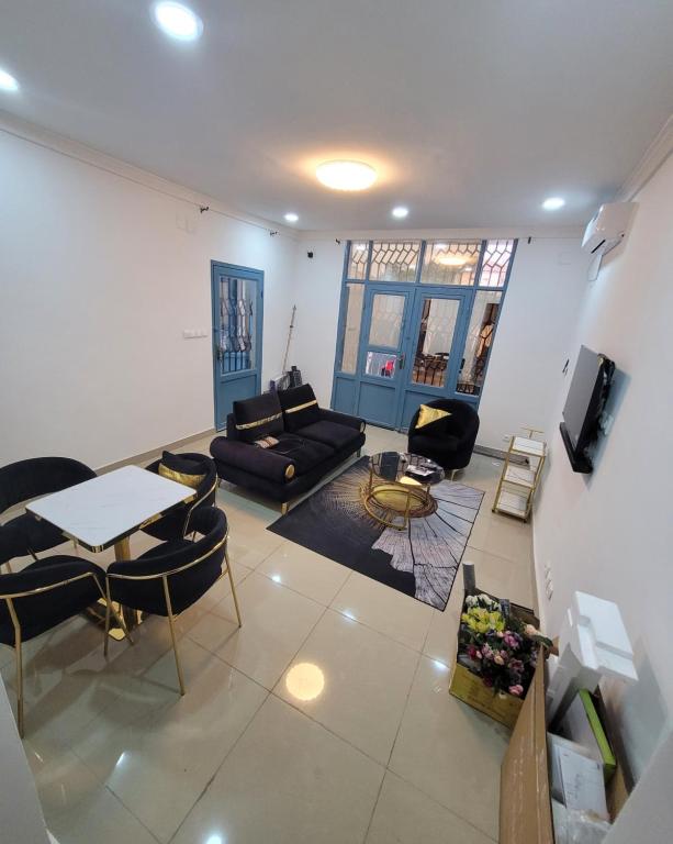 a living room with a couch and a table at Appartement Amani in Kinshasa