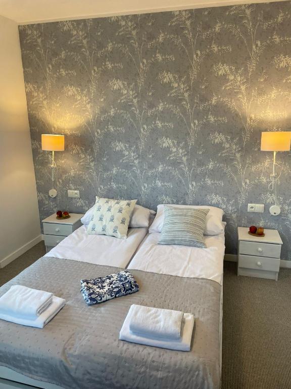 a bedroom with a bed with two towels on it at Apartament na Starówce in Zamość