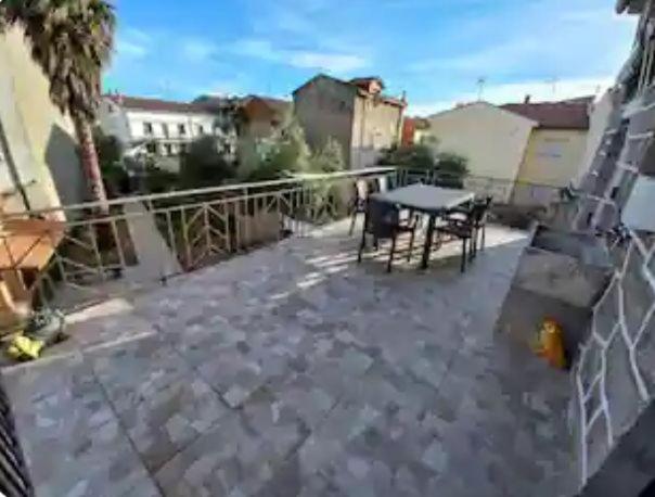 a view of a patio with a table and a fence at La Casita de Martina in Sotillo de la Adrada