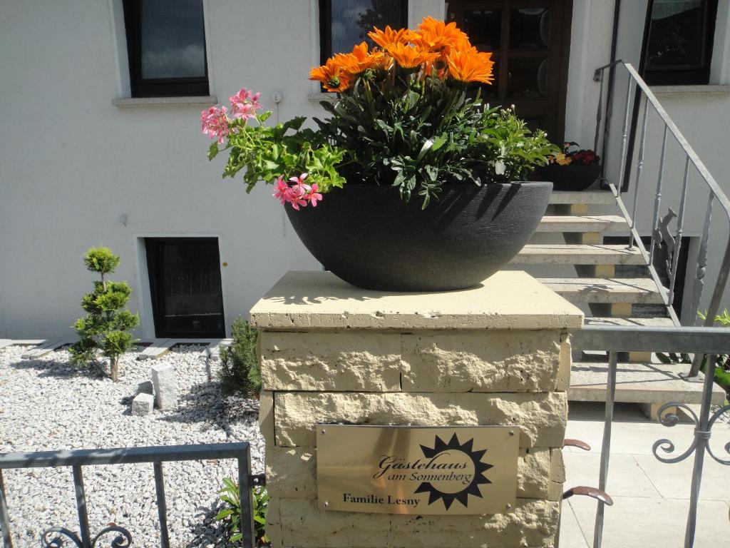 a pot of flowers sitting on top of a stone pillar at Gästehaus am Sonnenberg in Baunach