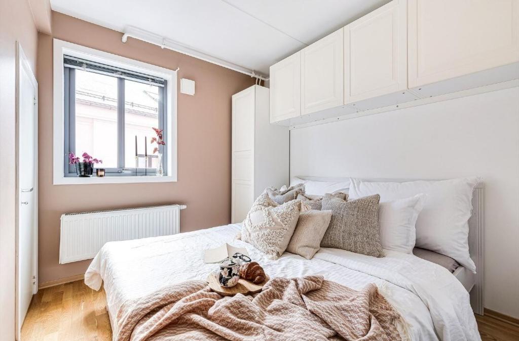 a bedroom with a bed with a teddy bear on it at Charming Duplex near the beautiful Akerselva river in Oslo