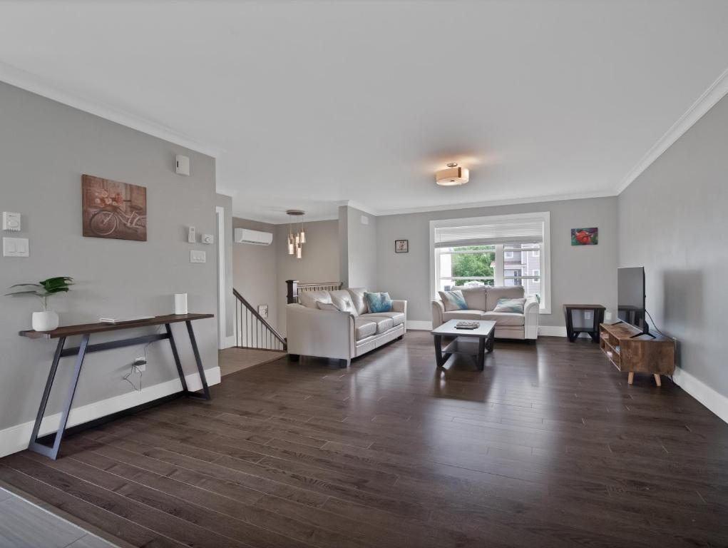 a living room with a couch and a table at Comfortable 3BR Getaway in Riverview