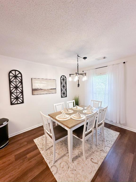 a dining room with a table and chairs at Crescent Gardens-3 Miles from UA in Tuscaloosa