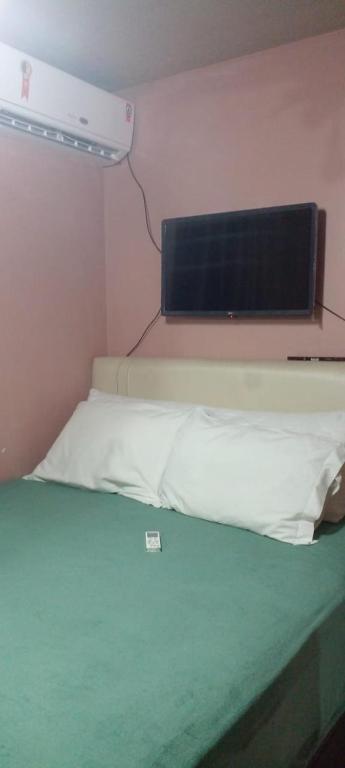 a room with a bed with a computer monitor on it at cris Gomes cop30 in Ananindeua