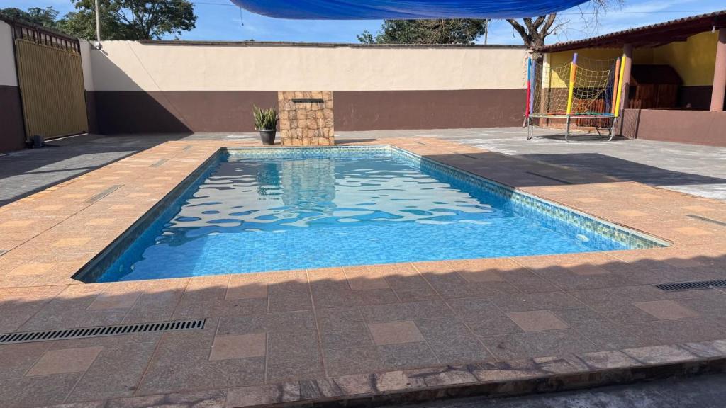 a swimming pool in the middle of a patio at Recanto SB in Campo Limpo