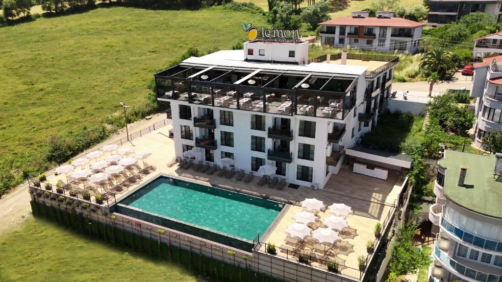 an aerial view of a building with a swimming pool at Lemon Suites & Restaurant in Korucuk