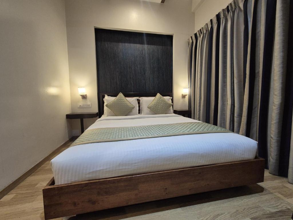 a bedroom with a large bed in a room at R D Hotels HSR in Bengaluru