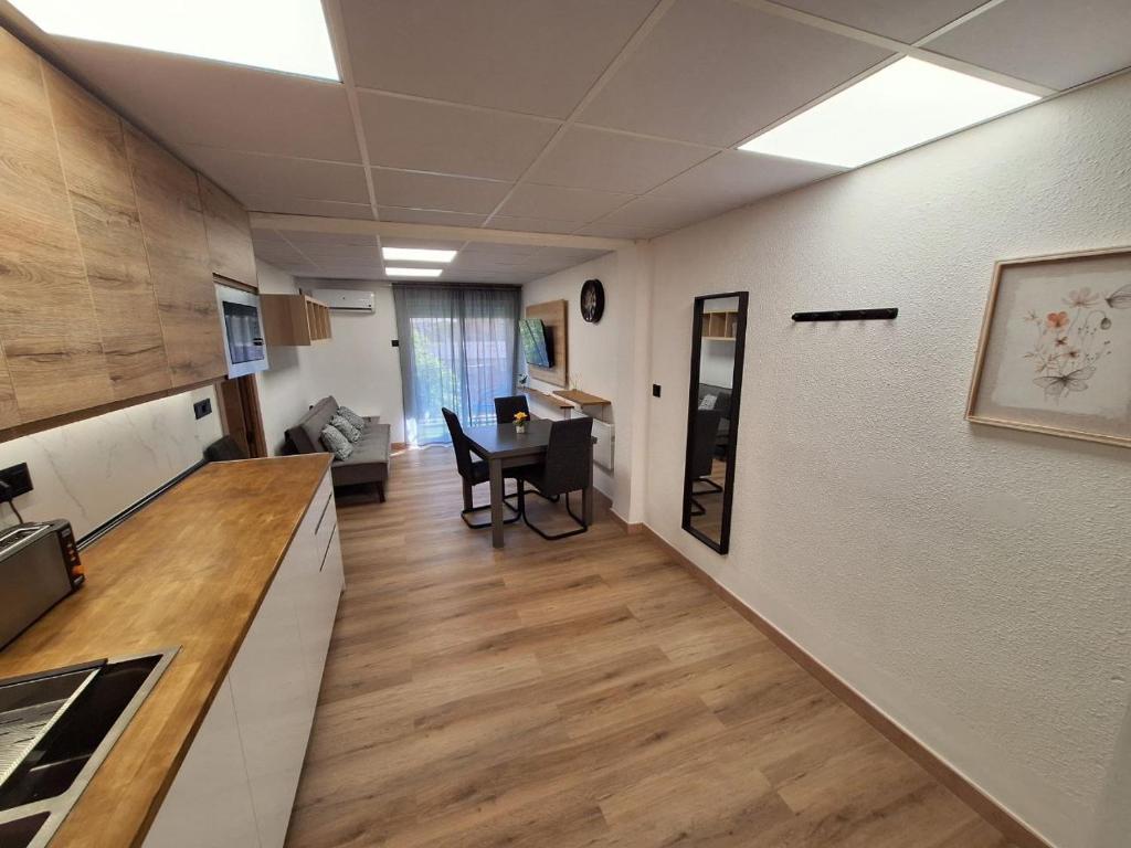 eine Küche und ein Wohnzimmer mit einem Tisch in einem Zimmer in der Unterkunft Piso Burjassot - Valencia in Burjasot