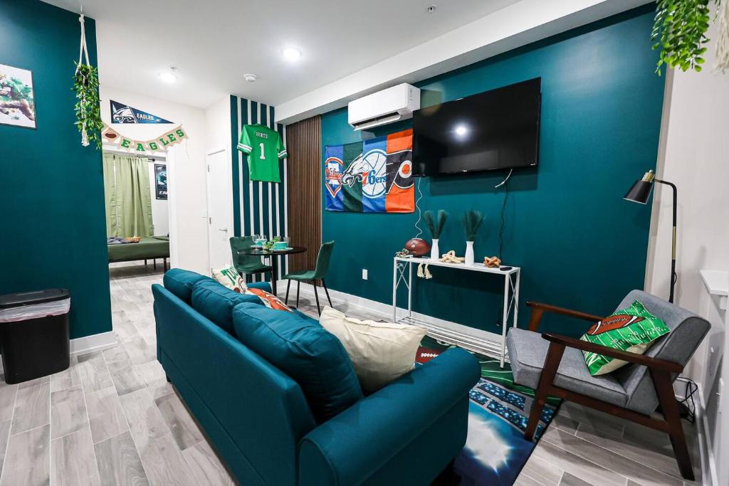 a blue living room with a blue wall at Perch in Paradise EaglesThemed Escape in Philadelphia