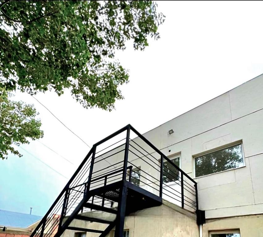 a building with a staircase on the side of it at Puesta del Sol Apart in Río Gallegos