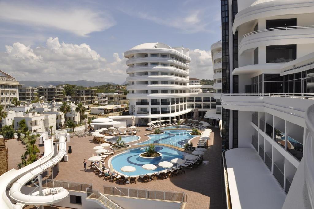 arial view of a resort with a swimming pool at Laguna Beach Alya Resort & Spa in Okurcalar