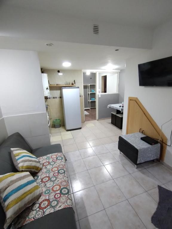 a living room with a couch and a kitchen at Huilliches NQN in Neuquén
