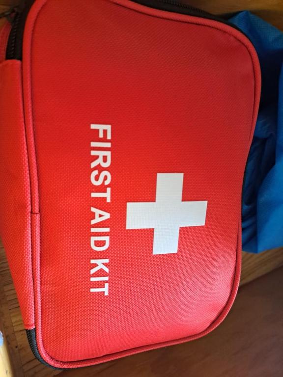 a red suitcase with a white cross on it at Etinoff's Apartments in Sutherlands Development