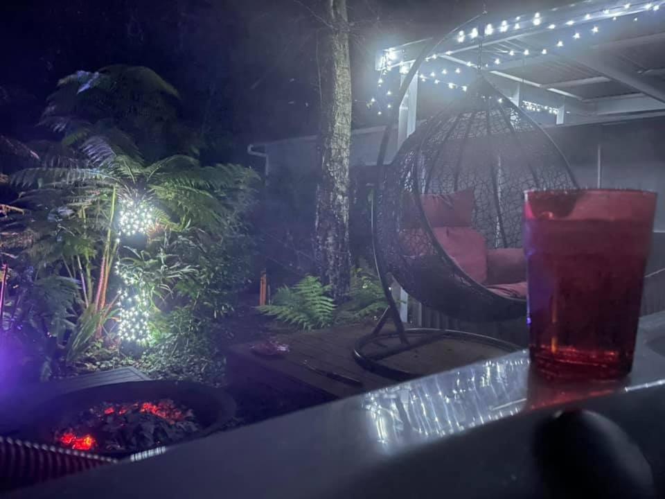 a drink on a table with a garden at night at Olinda Church House in Olinda