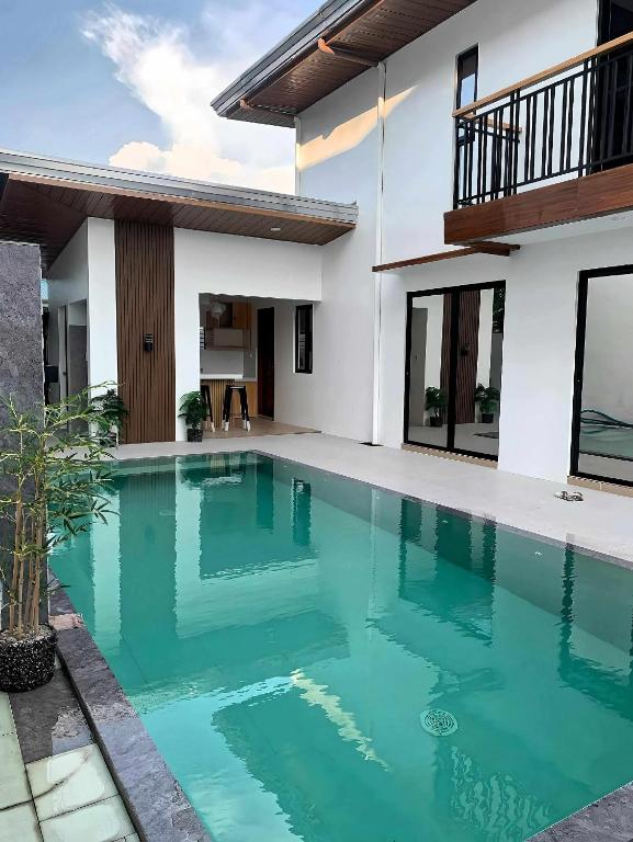 a swimming pool in the backyard of a house at The Hidden Escape in Sampong