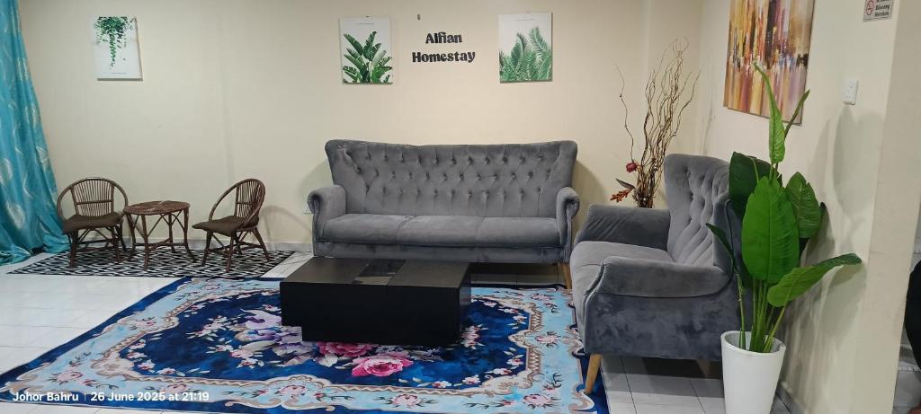 a living room with two chairs and a couch and a rug at Alfian Homestay in Johor Bahru