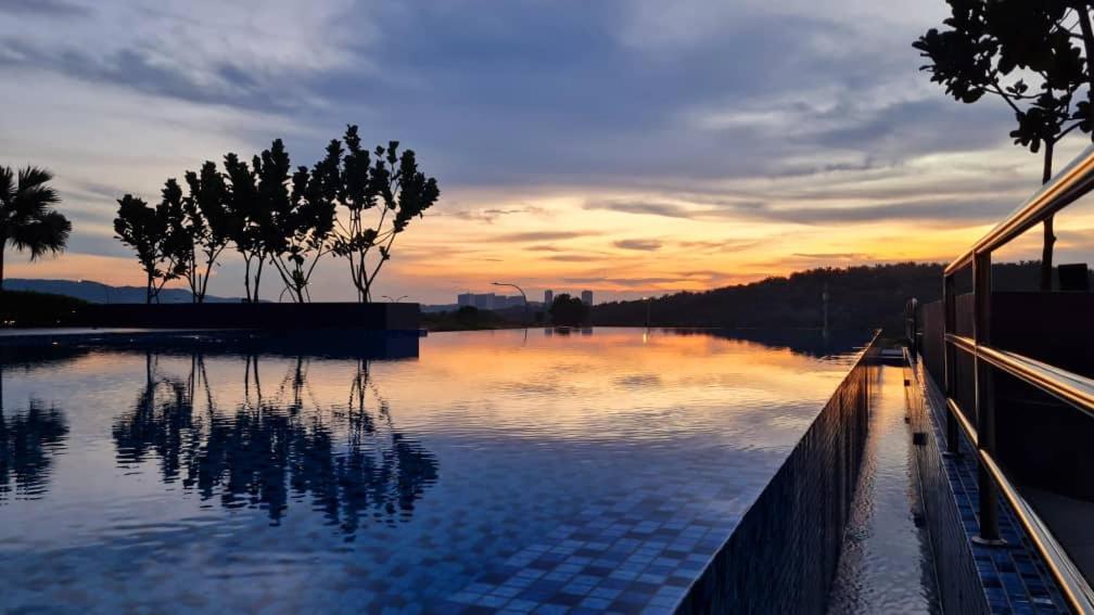 a large body of water with a sunset in the background at Alora Homestay in Kajang