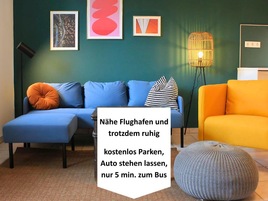 a living room with a blue couch and two chairs at Möbliert Wohnen Munich Airport Business Park in Hallbergmoos