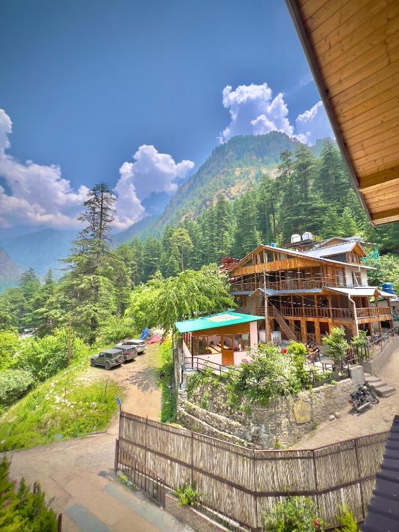 a view of a building with a mountain in the background at Royal Star Kasol in Kasol