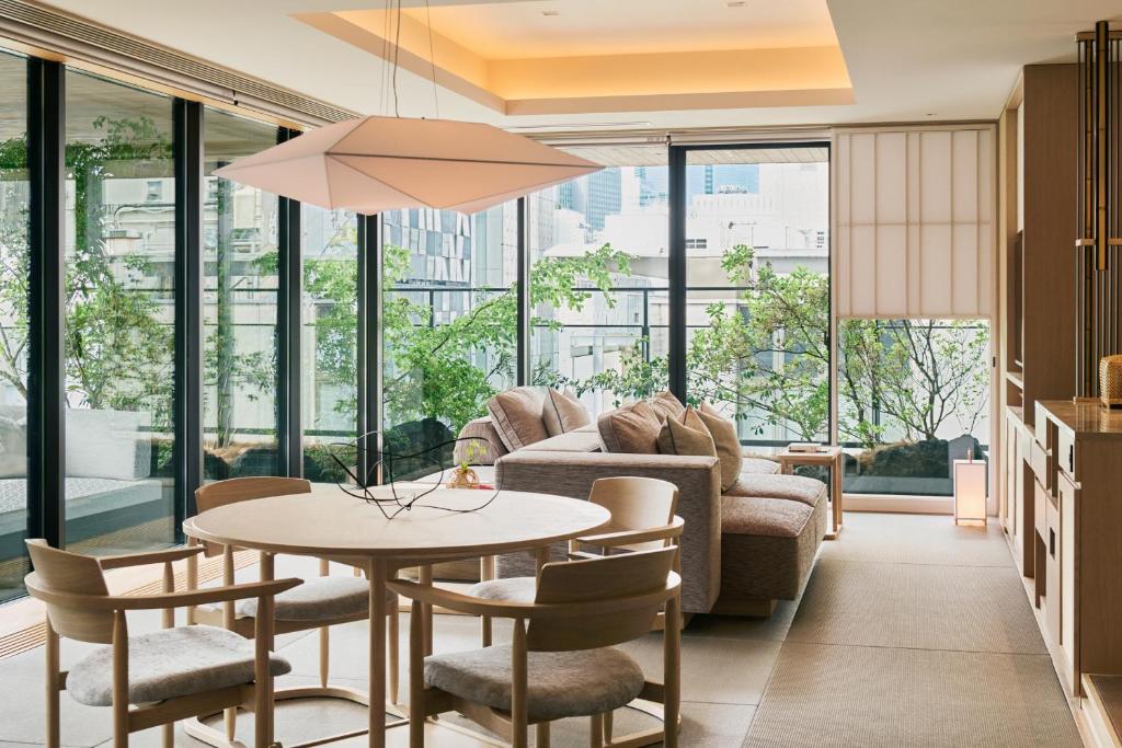 a living room with a couch and a table and chairs at ふふ東京銀座 in Tokyo