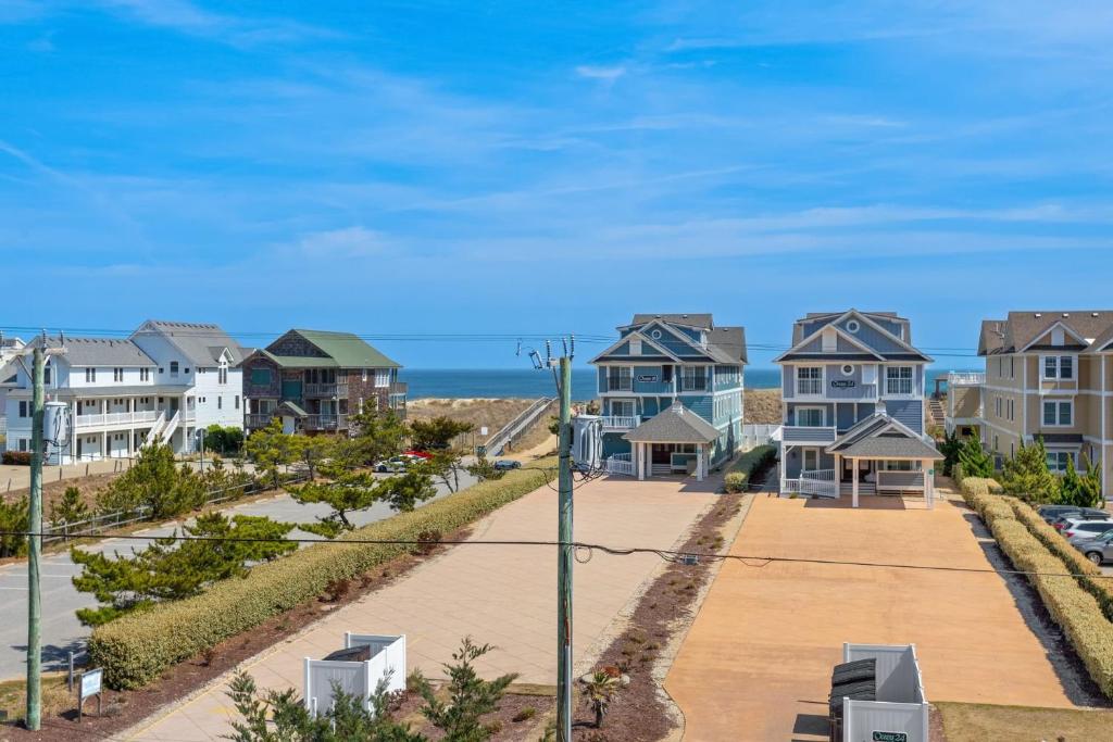 a row of houses with the ocean in the background at 5110 - Queen Elizabeth`s Castle in Croatan Shores
