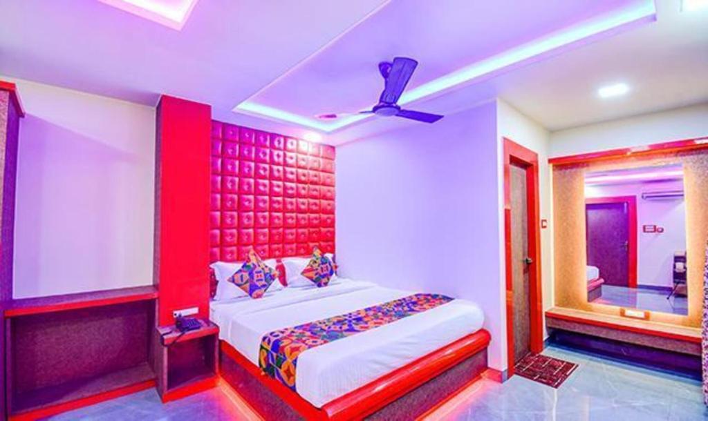 a bedroom with a large bed and a window at FabHotel The Crown Comforts in kolkata
