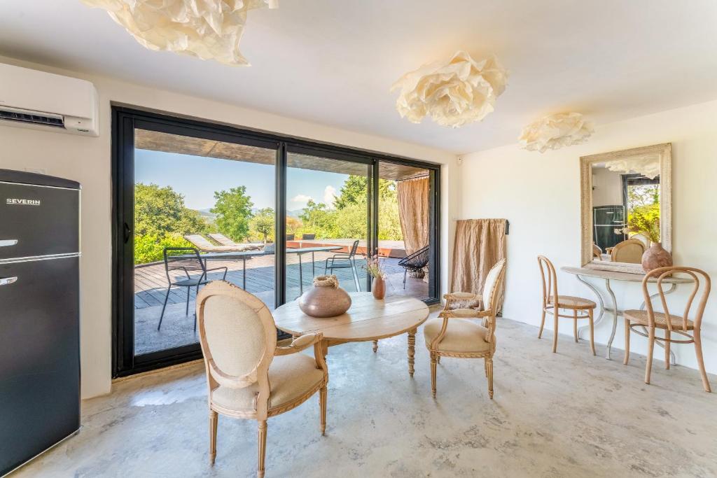 a kitchen and dining room with a table and chairs at Maisonk Provence in Villedieu