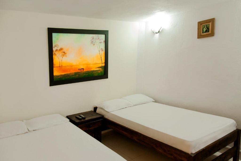 Postel nebo postele na pokoji v ubytování Finca Hotel La Ponderosa