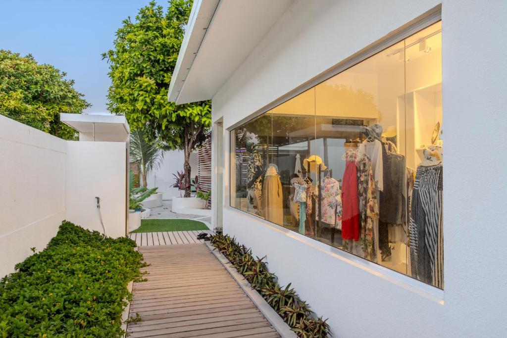 a building with a store window with dresses in it at Avenly Omadhoo in Omadhoo