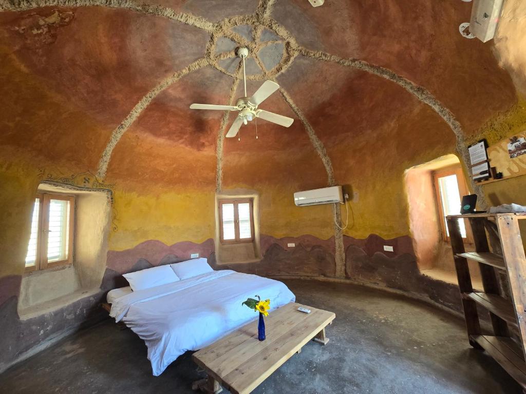 a bedroom with a bed in a room with a ceiling at Kibbutz Lotan Eco-Campus in Kibbutz Lotan