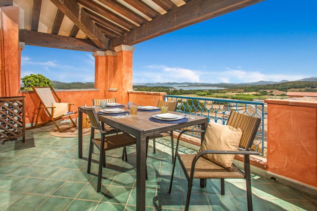 a table and chairs on a balcony with a view at BILANCIA VI 30' Porto Cervo & PRIVATE TERRACE with Sea View in Santa Teresa Gallura