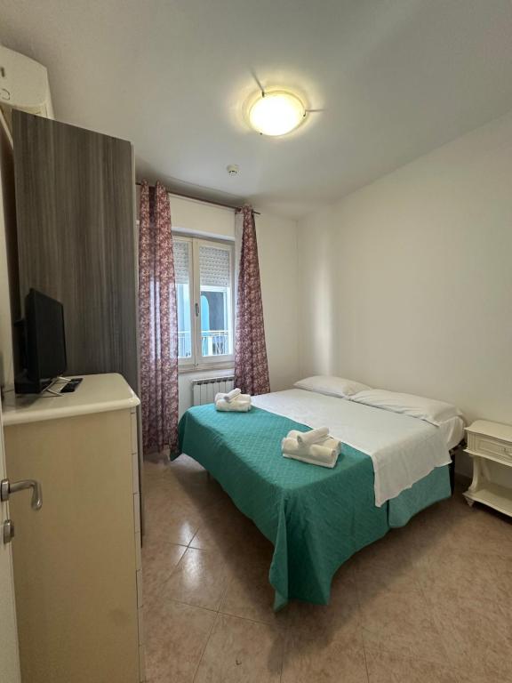 Postel nebo postele na pokoji v ubytování Hotel Ginevra e Residence