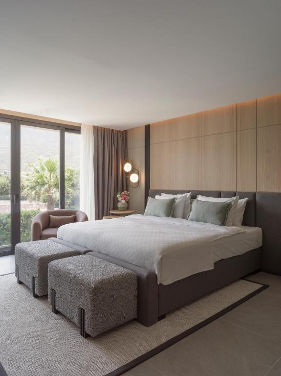 a bedroom with a large bed and a large window at kolektif suites in Kyrenia