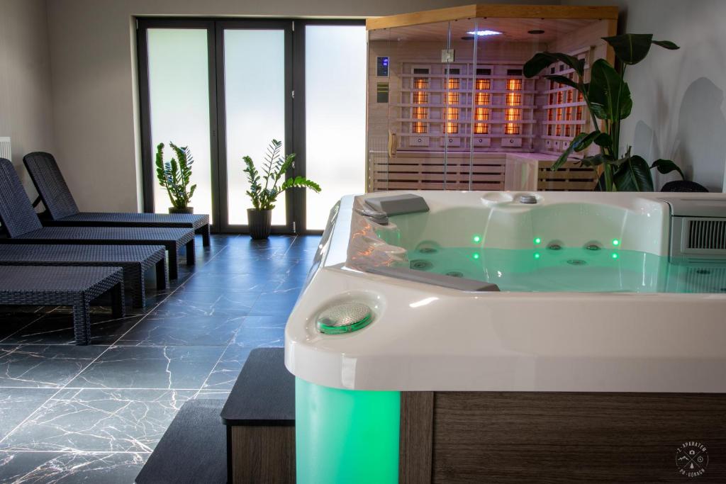 a jacuzzi tub in the middle of a room at Belle View Szklarska Poręba Strefa SPA - Jacuzzi & Sauna in Szklarska Poręba
