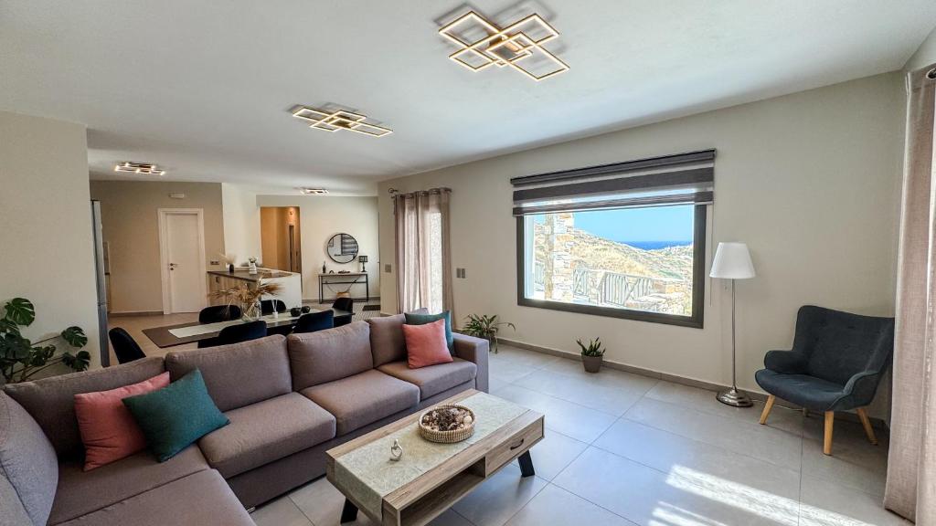 a living room with a couch and a table at La vie en Abela in Megas Gialos - Nites