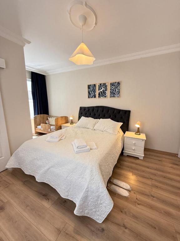 a bedroom with a large bed with a white blanket at Seaview 2BR 2BA Apartment in Antalya Lara Cliffs in Antalya