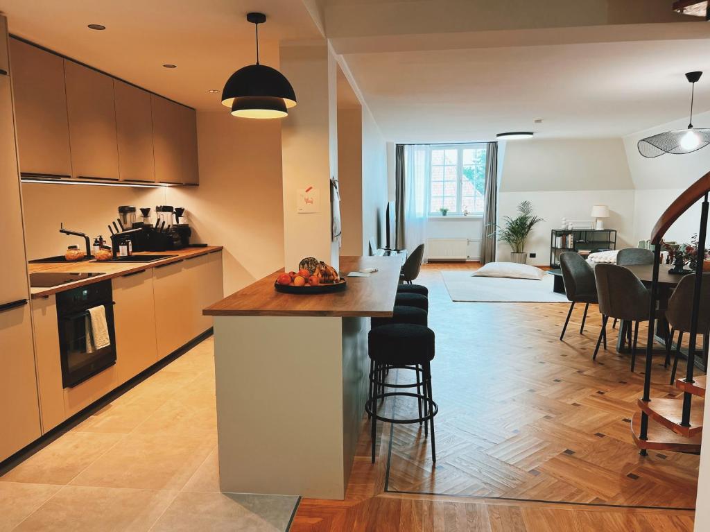 a kitchen with a island in the middle of a room at Space - Style - Prime location - Old Town views in Tallinn