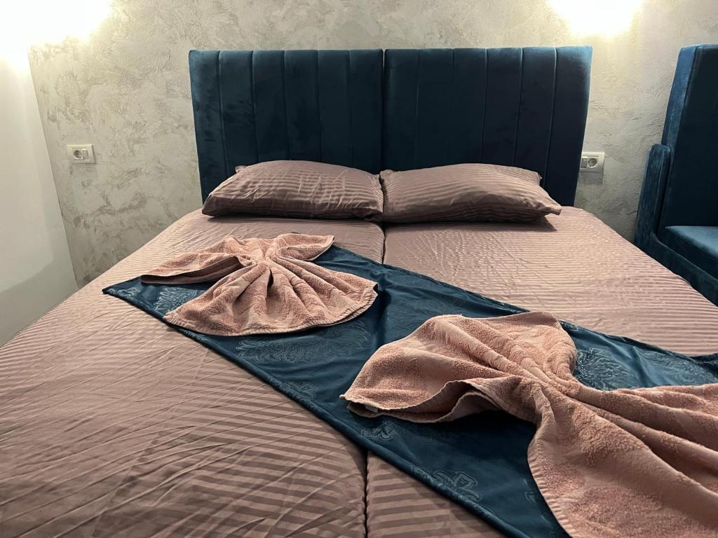 a bed with two blankets and pillows on it at Ama29 in Constanţa