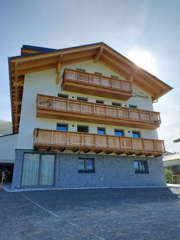 a building with wooden balconies on the side of it at Haus Sonneck in Nauders