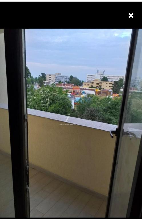 a window with a view of a city at BetaBlue Apartament in Saturn