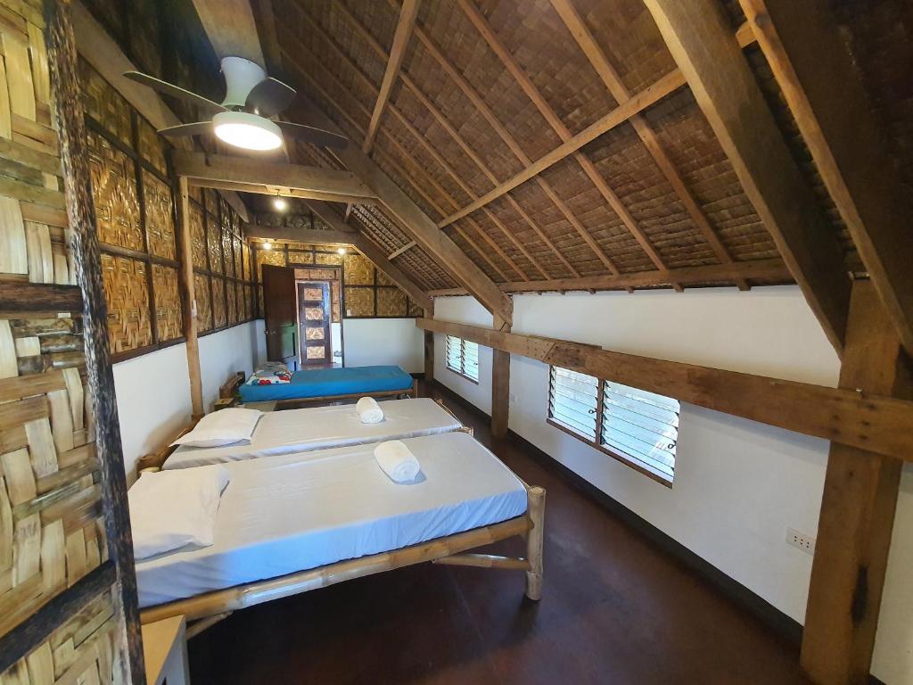 Postel nebo postele na pokoji v ubytování Coleto Siargao