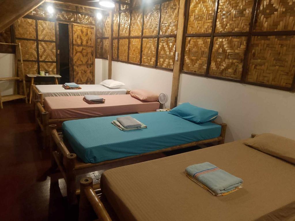 Postel nebo postele na pokoji v ubytování Coleto Siargao