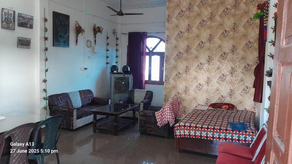 a living room with a couch and a table at Shri Satyanarayan ji homestay in Ayodhya
