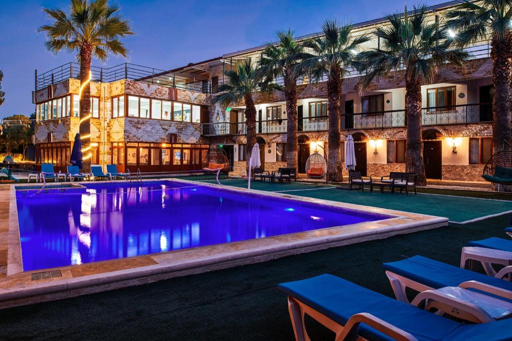 a hotel with a swimming pool in front of a building at Apollon Garden Pamukkale in Denizli