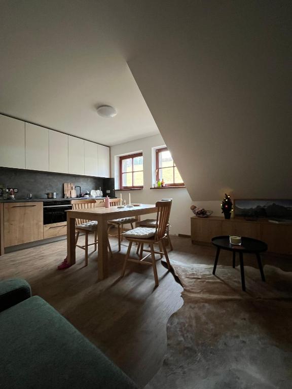 a kitchen with a table and chairs in a room at Apartmán Hájenka - Makov in Makov