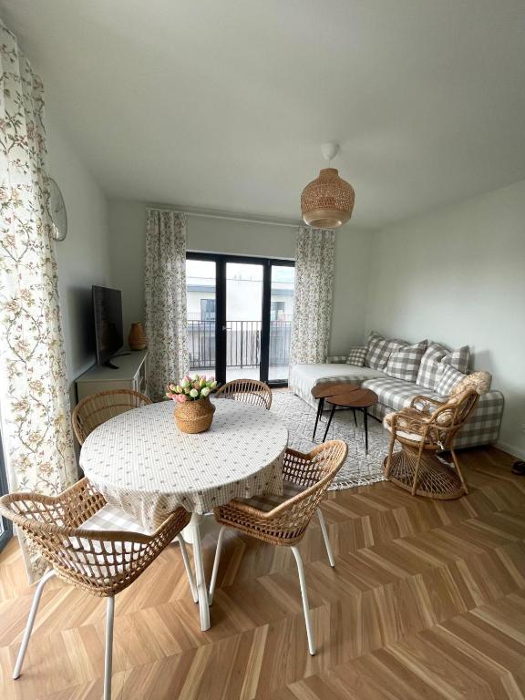 a living room with a table and chairs and a couch at Apartament Aleja Poetów in Chojnice